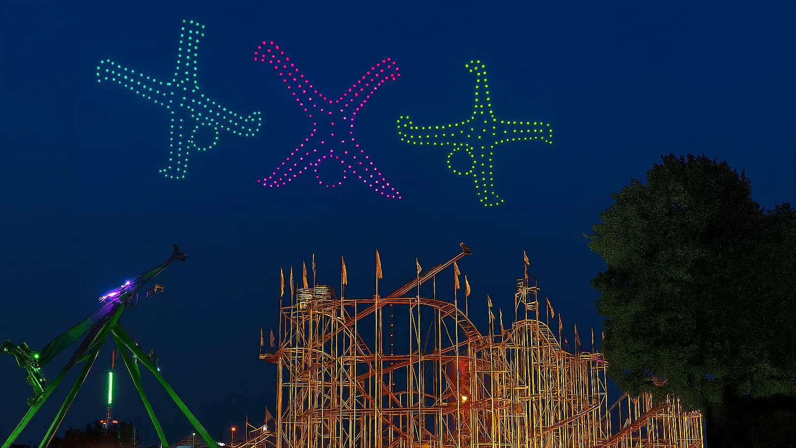 Kinderzahnheilkunde von Anfang an – RKM 740 Düsseldorf Bunte Lichtfiguren am Himmel über einem Freizeitpark – Sinnbild für spielerische Leichtigkeit und Vertrauen in der Kinderzahnheilkunde im RKM 740 Düsseldorf